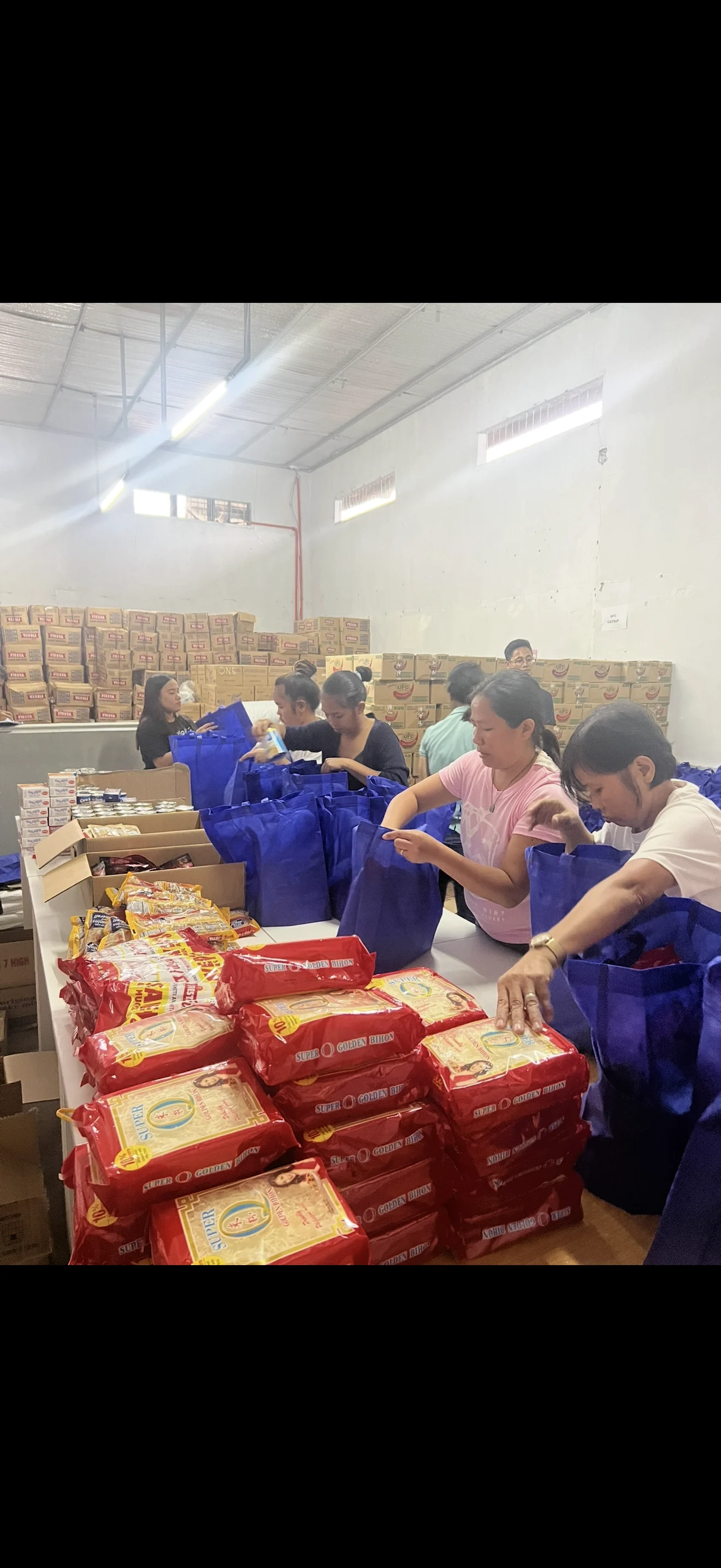 Team preparing grocery packages in a warehouse